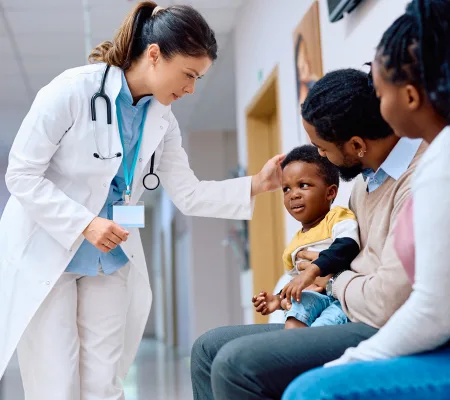 A doctor caring for a young patient and family